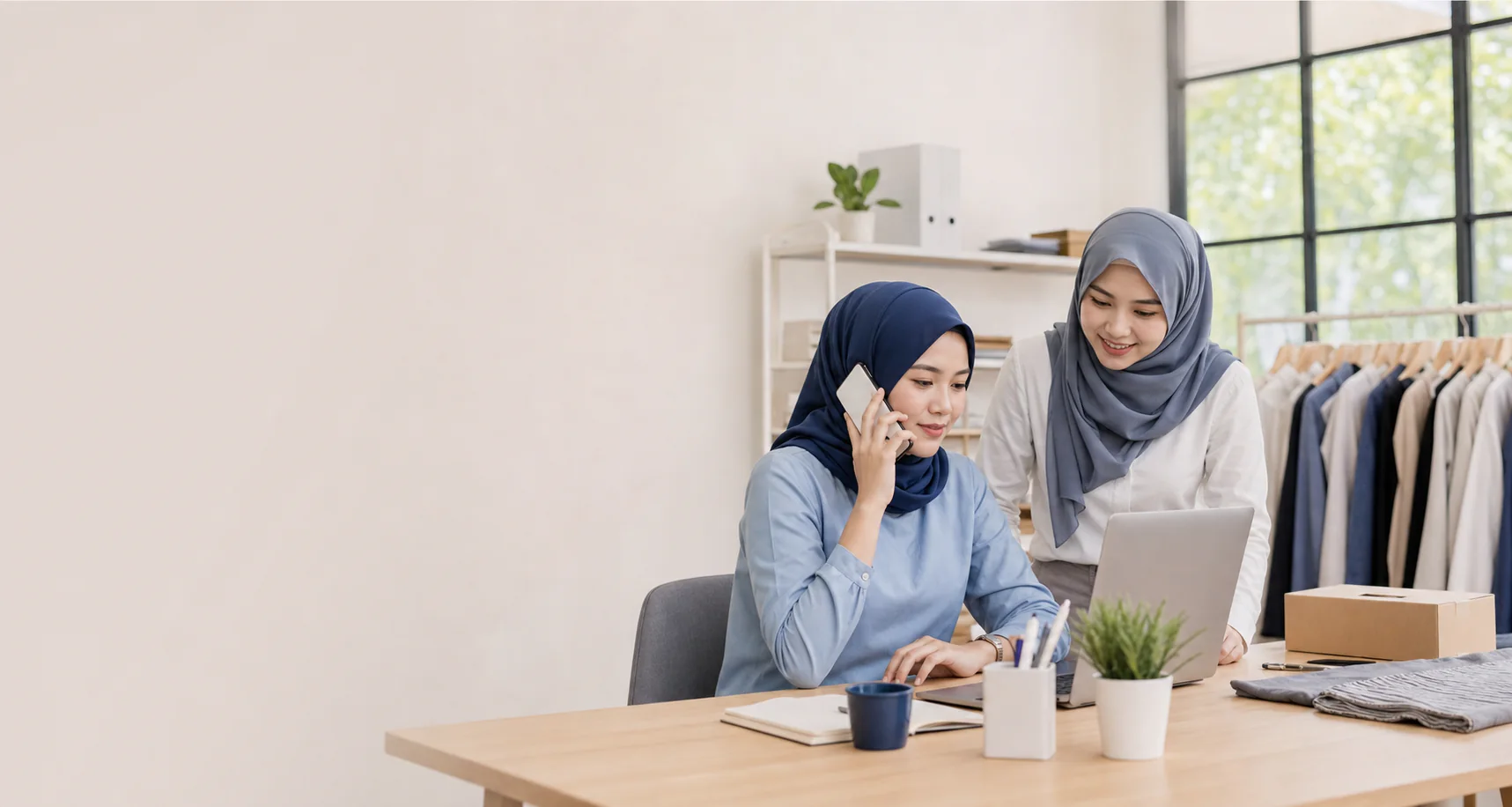 An Indonesian small-business team serving customers through WhatsApp and a laptop